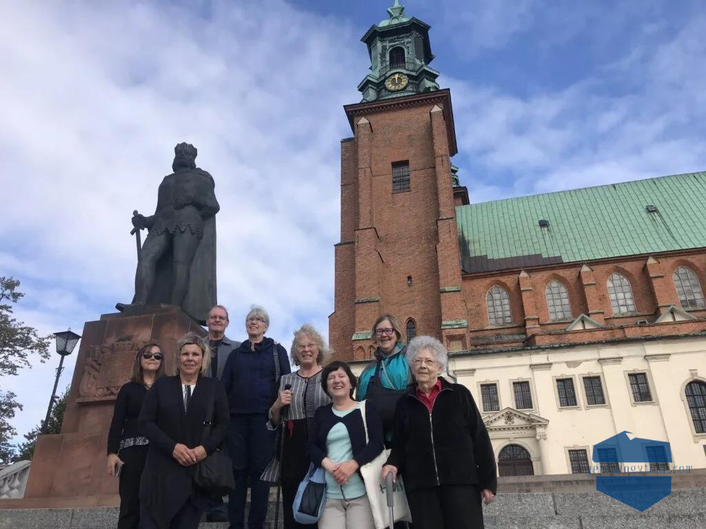 people standing in front of a monument, smiling